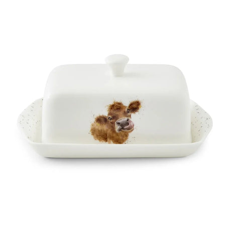 Royal Worcester Wrendale Covered Butter Dish featuring a charming illustration of a brown cow licking its nose, perfect for brightening up your dining table. Ideal for everyday use or gifting, this Wrendale Designs butter dish adds a delightful countryside touch.