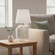 Ridged glass table lamp in clear finish, perfect for living room decor.