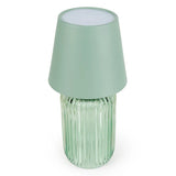 Scenic view of the Ridged Glass Table Lamp - Green on a table, a chic green table lamp for ambient lighting.