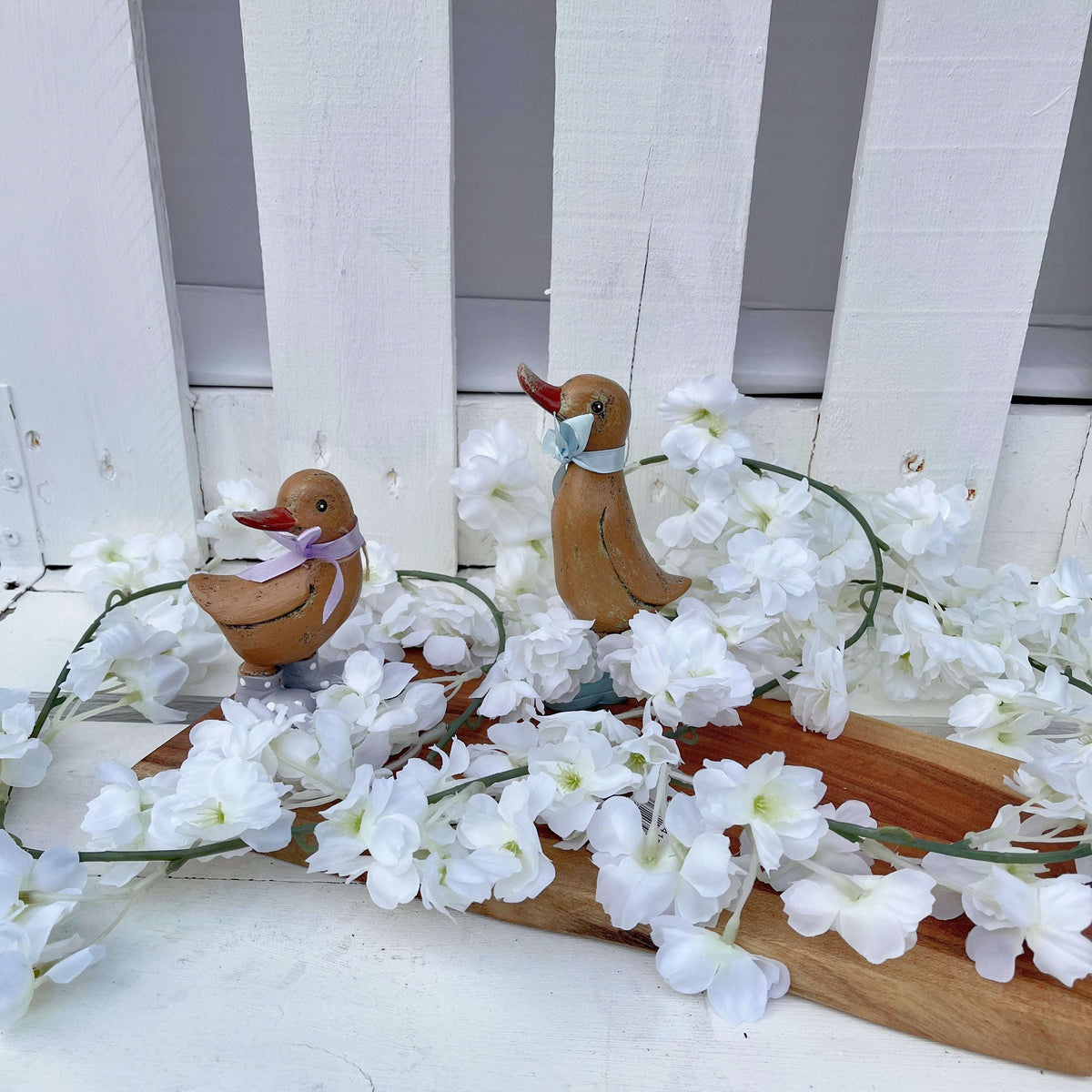 Silk Cherry Blossom Garland, Cream draped over a banister, adding a stylish touch with the silk cherry blossom garland.