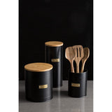 Typhoon Otto Black Cookie Storage canister alongside utensils, featuring a bamboo lid and stylish gold label for organization in every kitchen.
